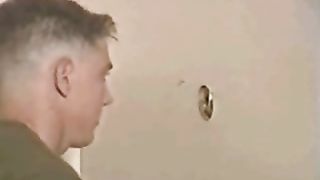 Gay guy sucking on a huge dick at the glory hole