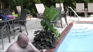 Two fat bears lick and suck each other by the pool