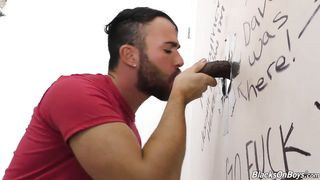 Bearded guy sucking off a black cock at a gloryhole
